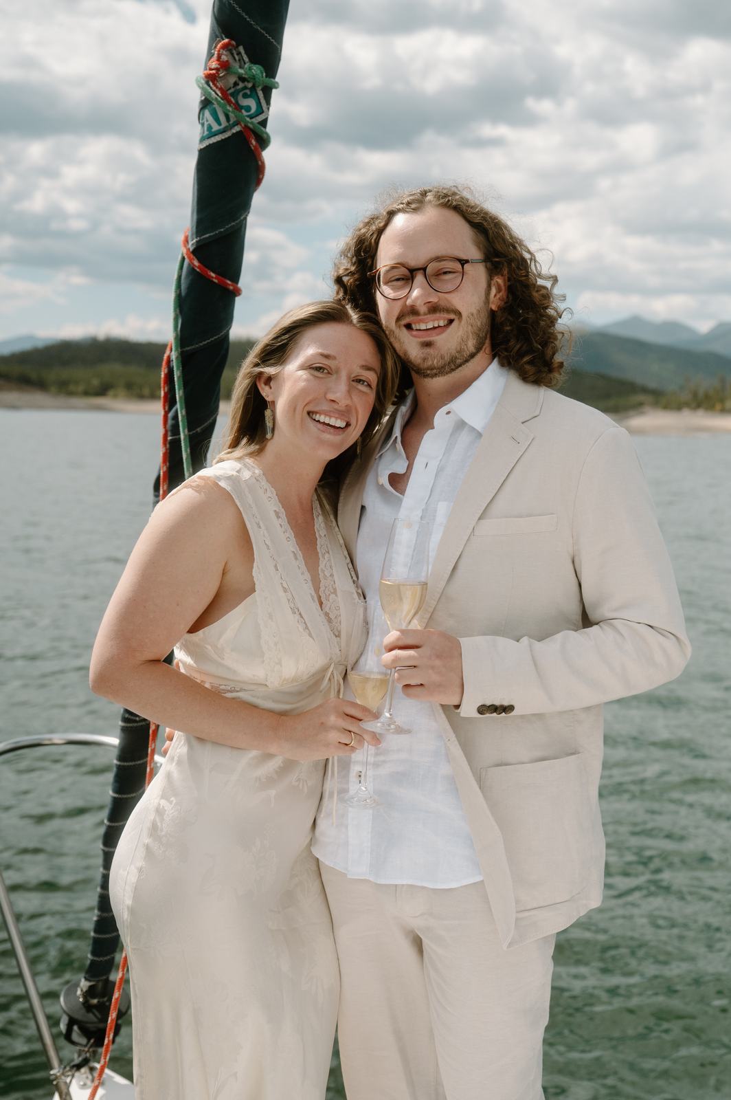 Lauren and Christopher smiling together on the sailboat